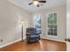 Comfortable bedroom showcasing hardwood floors, a reading chair, and dual windows that bring in natural light at 8451 Walsham St, North Charleston, SC 29420