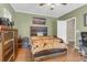 Comfortable bedroom with wood floors and a coordinating dresser, creating a relaxing and stylish retreat at 8451 Walsham St, North Charleston, SC 29420