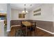 Charming dining space featuring a chandelier, wood floors, and convenient access to the adjacent kitchen at 8451 Walsham St, North Charleston, SC 29420