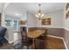 Comfortable dining room area with stylish chandelier, complemented by hardwood floors and easy access to the kitchen at 8451 Walsham St, North Charleston, SC 29420
