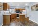 Functional kitchen layout with wood cabinets, an island, and ample counter space for easy meal preparation at 8451 Walsham St, North Charleston, SC 29420