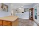 Bright, open kitchen space with an island, tile flooring, and neutral tones that create an inviting atmosphere at 8451 Walsham St, North Charleston, SC 29420