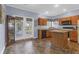 Efficient kitchen featuring wood cabinetry, an island, and seamless transition to a private backyard space at 8451 Walsham St, North Charleston, SC 29420