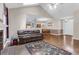 Cozy living room transitions into dining, showcasing hardwood floors, fireplace, and easy access to kitchen at 8451 Walsham St, North Charleston, SC 29420