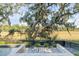 Private pool area with modern patio, seating, and tranquil scenery, creating an ideal outdoor retreat at 853 Whispering Marsh Dr, Charleston, SC 29412