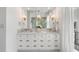Primary bathroom featuring a double sink vanity with marble countertop, gold fixtures, and large mirror at 853 Whispering Marsh Dr, Charleston, SC 29412