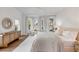 A spacious bedroom with floor to ceiling windows, hardwood floors and stylish furniture at 853 Whispering Marsh Dr, Charleston, SC 29412