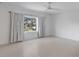 Large, well-lit bedroom features white walls and ceiling fan, window with bright natural light and turquoise accents at 853 Whispering Marsh Dr, Charleston, SC 29412