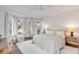 This primary bedroom is filled with natural light from a bay window overlooking the wooded backyard at 853 Whispering Marsh Dr, Charleston, SC 29412