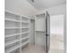 Well-organized walk-in closet with built-in shelving and open space for hanging clothes and storage at 853 Whispering Marsh Dr, Charleston, SC 29412