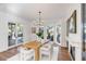 Dining room with floor-to-ceiling windows, hardwood floors, modern chandelier, and access to outdoor space at 853 Whispering Marsh Dr, Charleston, SC 29412