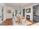 Dining room with large windows, hardwood floors, modern lighting, and a view of the fireplace at 853 Whispering Marsh Dr, Charleston, SC 29412