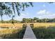 Picturesque view of private wooden dock surrounded by tranquil marshland under a sunny sky at 853 Whispering Marsh Dr, Charleston, SC 29412