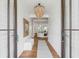 Bright foyer with wood floors, shiplap walls, and an elegant chandelier at 853 Whispering Marsh Dr, Charleston, SC 29412