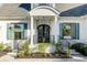Inviting home entrance showcasing a columned porch and meticulously landscaped front yard at 853 Whispering Marsh Dr, Charleston, SC 29412