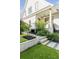 Beautifully landscaped front yard with manicured lawn, stone steps, and decorative plantings at 853 Whispering Marsh Dr, Charleston, SC 29412