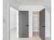 Bright hallway features wainscoting, gray doors, and a view into a closet with built-in shelving at 853 Whispering Marsh Dr, Charleston, SC 29412