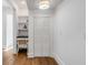 Bright hallway featuring a built-in desk with shelving, a closet with bi-fold doors and hardwood floors at 853 Whispering Marsh Dr, Charleston, SC 29412