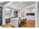 Bright, white kitchen with hardwood floors, center island, stainless steel appliances, and stylish pendant lighting at 853 Whispering Marsh Dr, Charleston, SC 29412