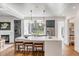 Modern kitchen featuring a large marble island, stainless steel appliances, and wooden bar stools at 853 Whispering Marsh Dr, Charleston, SC 29412