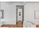 Bright living room with shiplap walls and ceiling beams, an open doorway, and hardwood floors at 853 Whispering Marsh Dr, Charleston, SC 29412