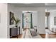 Cozy living room features stylish decor, hardwood floors, and a view to the outside through a large window at 853 Whispering Marsh Dr, Charleston, SC 29412