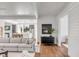 Open-concept living room showcasing hardwood floors, white walls, and seamless access to the kitchen at 853 Whispering Marsh Dr, Charleston, SC 29412