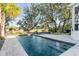 Inviting pool area surrounded by lush trees and landscaping, perfect for outdoor relaxation and recreation at 853 Whispering Marsh Dr, Charleston, SC 29412