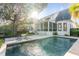 Stunning backyard oasis featuring a private pool, screened porch, and lush landscaping at 853 Whispering Marsh Dr, Charleston, SC 29412