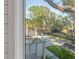 Backyard view of a private pool and patio area surrounded by lush landscaping and oak trees at 853 Whispering Marsh Dr, Charleston, SC 29412