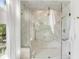 A glass enclosed marble tiled shower featuring both rainfall and handheld shower heads plus a built-in seat at 853 Whispering Marsh Dr, Charleston, SC 29412
