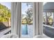 A tranquil view of the pool and wooded back yard through an elegant bedroom bay window at 853 Whispering Marsh Dr, Charleston, SC 29412