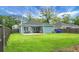 Wide backyard view highlighting a large, fenced yard and patio, great for entertaining at 8703 Jenny Lind St, North Charleston, SC 29406