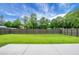Fenced backyard showcasing a large grassy area, ideal for recreation and outdoor activities at 8703 Jenny Lind St, North Charleston, SC 29406