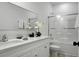 Clean bathroom offers double sinks, white cabinets, quartz countertops, and a shower-tub combo with glass doors at 8703 Jenny Lind St, North Charleston, SC 29406