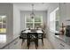 Dining area with a dark wood table, decorative pendant light, and plenty of natural light from large windows at 8703 Jenny Lind St, North Charleston, SC 29406