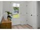 Inviting entryway with light wood floors, white doors, and natural light at 8703 Jenny Lind St, North Charleston, SC 29406