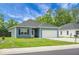 Well-kept single-story home with blue siding, a two-car garage, and lush green lawn at 8703 Jenny Lind St, North Charleston, SC 29406