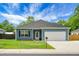 Beautiful single-story home with blue siding, an attached garage, and a well-manicured lawn at 8703 Jenny Lind St, North Charleston, SC 29406
