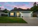 Charming single-story home with teal siding, a well-maintained lawn, and a two-car garage at 8703 Jenny Lind St, North Charleston, SC 29406