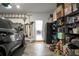 Spacious garage with organized storage shelves, tools, car, and view of a dining table at 8703 Jenny Lind St, North Charleston, SC 29406