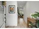 Bright hallway with light wood floors, white wainscoting, and recessed lighting at 8703 Jenny Lind St, North Charleston, SC 29406