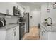 Bright, modern kitchen with white cabinets, granite countertops, stainless steel appliances, and an island with sink at 8703 Jenny Lind St, North Charleston, SC 29406