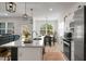 Bright kitchen with sleek appliances, island seating, modern cabinets and an adjoining dining area at 8703 Jenny Lind St, North Charleston, SC 29406
