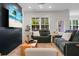 Relaxing living room with a large tv, wood-look flooring, and comfortable seating is perfect for entertaining at 8703 Jenny Lind St, North Charleston, SC 29406