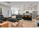 Open-concept living room with island seating, a large window, and sleek design is perfect for entertaining at 8703 Jenny Lind St, North Charleston, SC 29406
