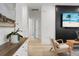 Bright living room features modern decor, light wood floors, and a stylish accent wall with a large screen TV at 8703 Jenny Lind St, North Charleston, SC 29406