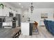 Open-concept living area featuring modern kitchen, island seating, and a comfortable living space at 8703 Jenny Lind St, North Charleston, SC 29406