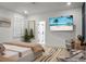 Spacious main bedroom features stylish decor, tv, neutral colors, with natural light from a window at 8703 Jenny Lind St, North Charleston, SC 29406