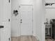 Well-lit mud room features a white door, light floors, and a utility sink at 8703 Jenny Lind St, North Charleston, SC 29406
